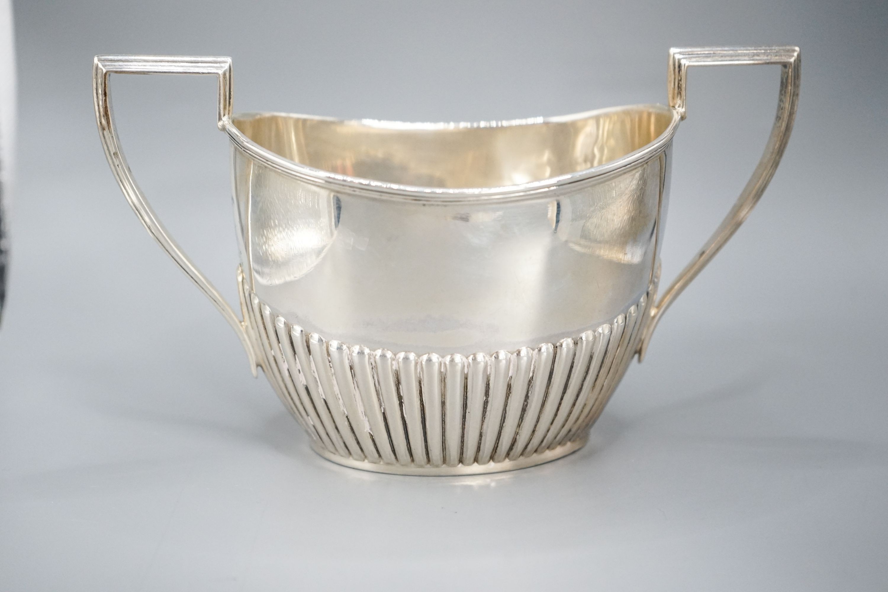 A late Victorian fluted silver cream jug and matching sugar bowl, by Walker & Hall, Sheffield, 1892/3, 13oz.